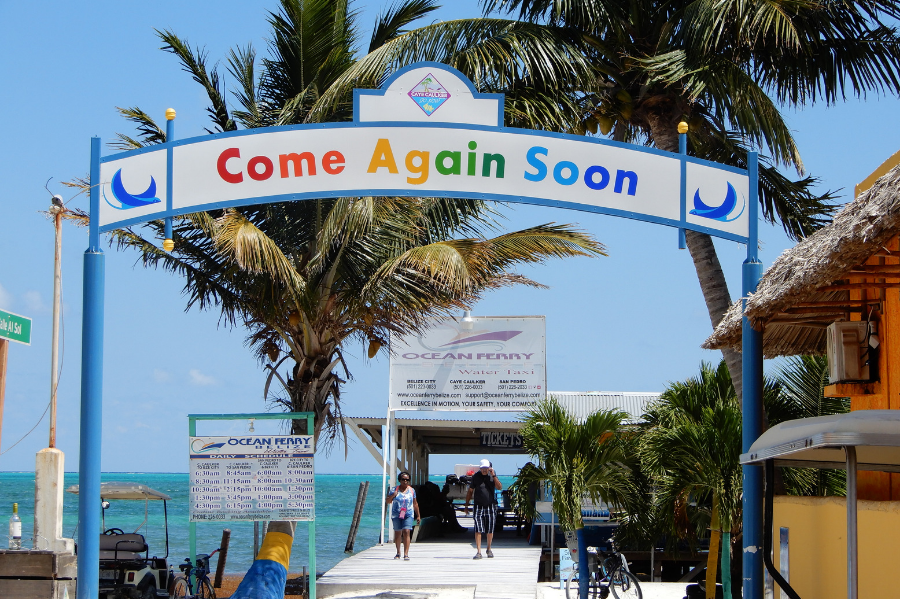 Caye Caulker Come Again Soon sign on beach